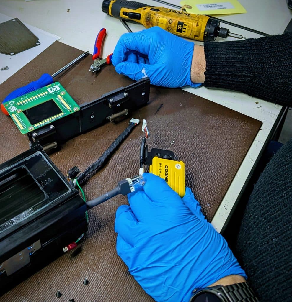 Technische reparatie van elektronisch component met handschoenen