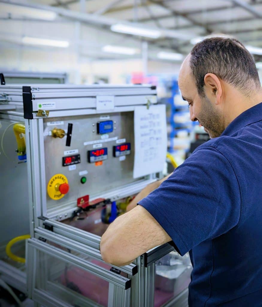 Technicus werkt aan industriële meet- en regelsysteemkast in een werkplaats